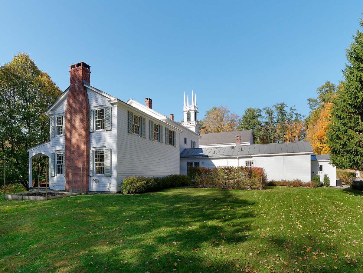 A historic home privately situated beside a church atop a hill with incredible views of southern Albany County, and an adorable studio out building? Yes, please. This retreat-like 1830 painted brick Federal-style home located at 14 Trinity Lane in Rensselaerville was once a parsonage for clergy at the adjacent church which is still in use today. The home oozes charm and features four bedrooms, a formal parlor, an assortment of built-ins and a mix of carpet and hardwood flooring. A whimsical fish motif wallpaper emblematic of Italian artist Piero Fornasetti's (1913-1988) work in one of the three-and-a-half bathrooms is particularly eye-catching. French doors in the farmhouse-style kitchen open to a pond and butterfly garden. On the literal edge of the property sits a quaint building that would make a great office, studio or cozy place to escape.  Listing price: $699,000. Taxes: $10,800. To learn more, contact listing agent James T. Male with HOUSE Hudson Valley Realty at james@househudsonvalley.com or (518) 697-9390.