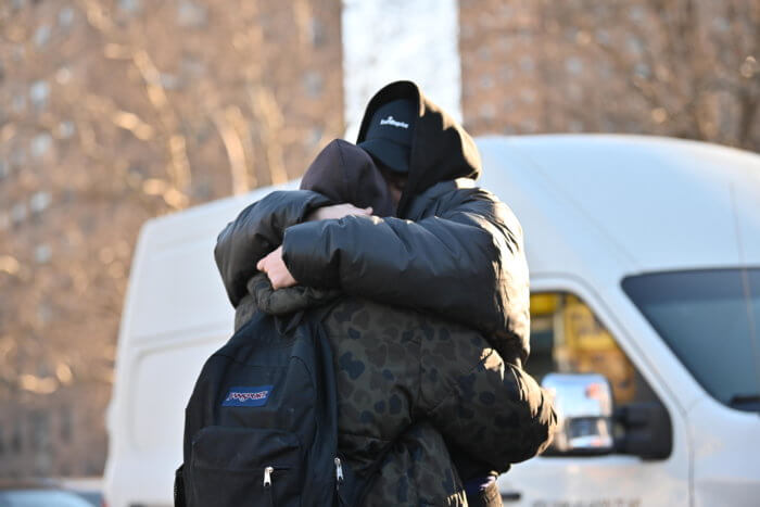 people hug outside williamsburg charter high school