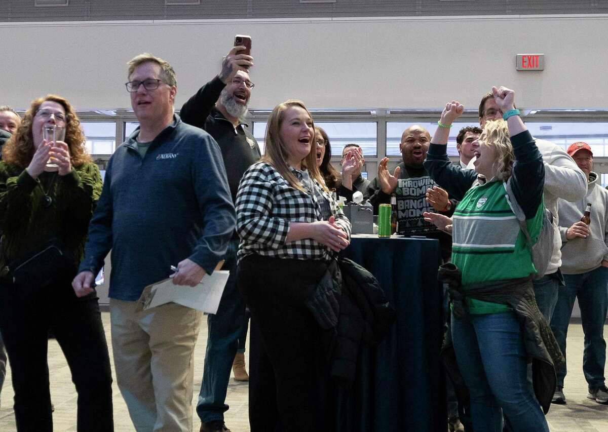 Spectators react to the announcement of who will play in Albany for March Madness at MVP Arena during the 2023 brackets Watch Party on Sunday, Mar. 12. (Jenn March, Special to the Times Union)