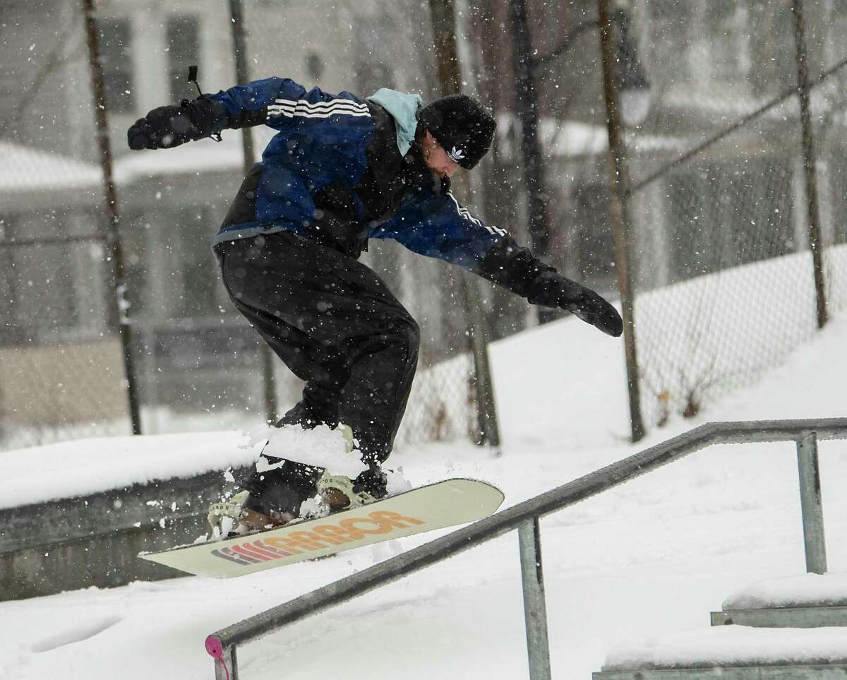 Dave Zito of Ghent enjoys the new snow snowboarding at the skatepark in Washington Park during a snow storm on Tuesday, March 14, 2023 in Albany, N.Y.