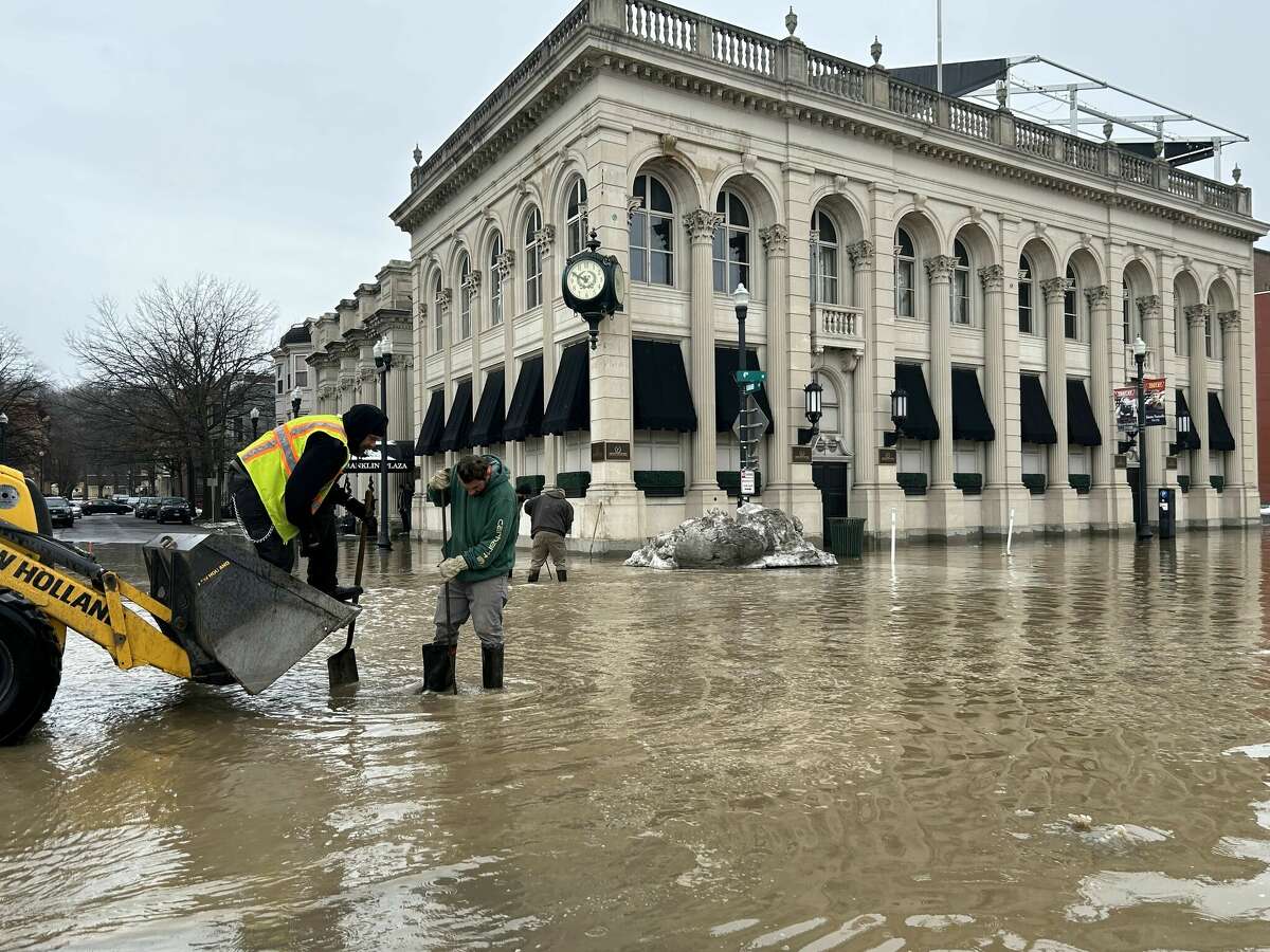 City crews work to clean out drains after water flooded streets in Troy around 4th and Federal streets Friday, March 17, 2023 following a water main break.