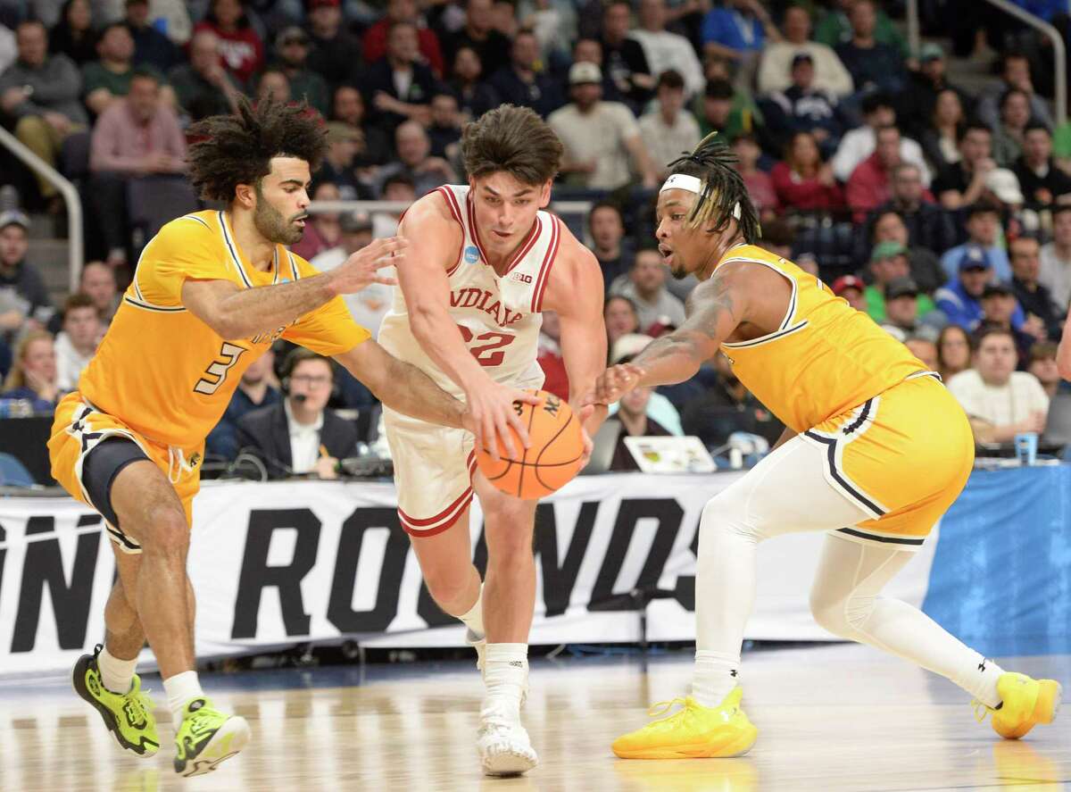 Indiana’s Trey Galloway charges through Kent State’s Sincere Carry (3) and VonCameron Davis during their game in the first round of the NCAA Men’s Basketball tournament at MVP Arena in Albany, N.Y., on Friday, Mar. 17, 2023. (Jenn March, Special to the Times Union)