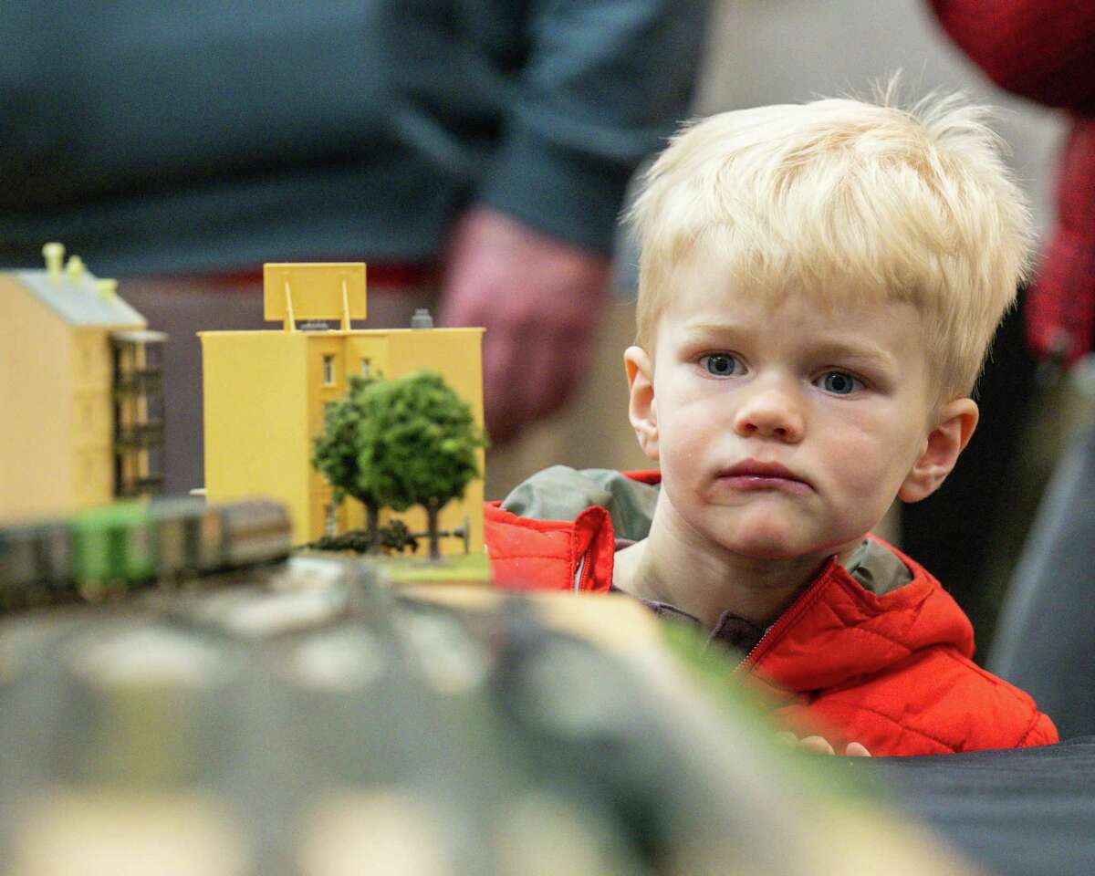 Harvey Martin looks around a model building at an oncoming model train at the Albany Train Show on Saturday, March 18, 2023, at the Polish Community Center in Albany, NY.