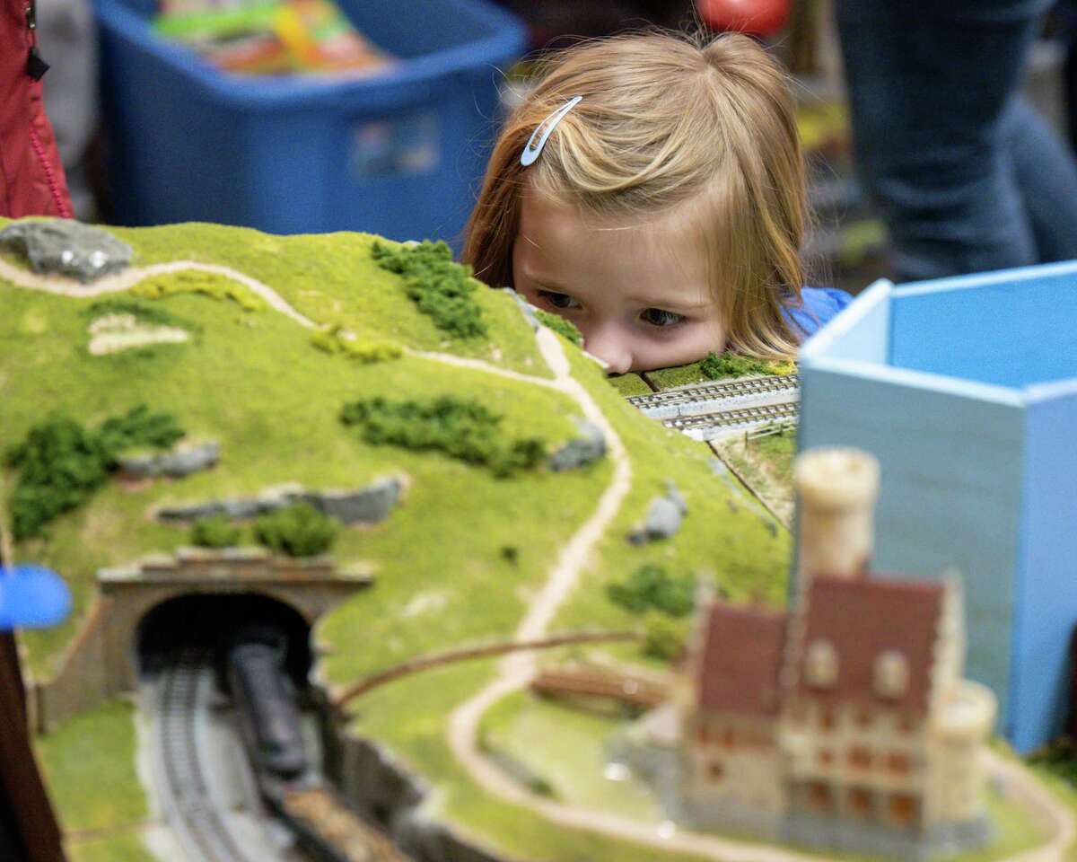 Vida Hacker waits for a model train to come through a tunnel Albany Train Show on Saturday, March 18, 2023, at the Polish Community Center in Albany, NY.