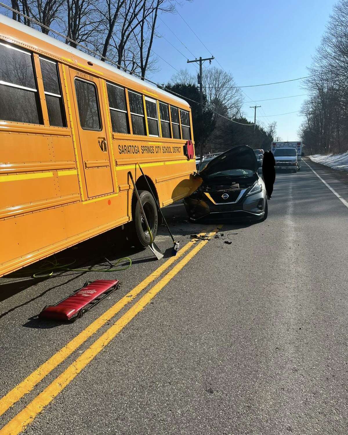 A car hit a Saratoga Springs school bus while it was stopped to pick up students Tuesday. The students were not hurt.