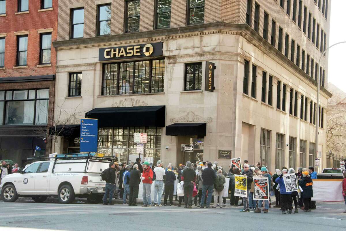 People participate in a climate march downtown to protest banks financing the fossil fuel industry on Tuesday, March 21, 2023 in Albany, N.Y.