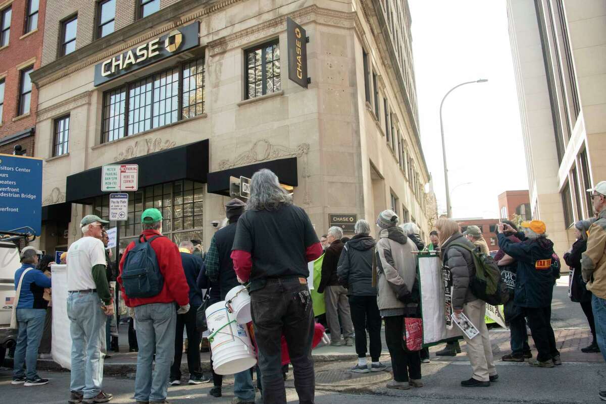 People participate in a climate march downtown to protest banks financing the fossil fuel industry on Tuesday, March 21, 2023 in Albany, N.Y.