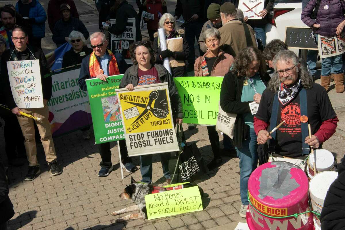 People participate in a climate march downtown to protest banks financing the fossil fuel industry on Tuesday, March 21, 2023 in Albany, N.Y.