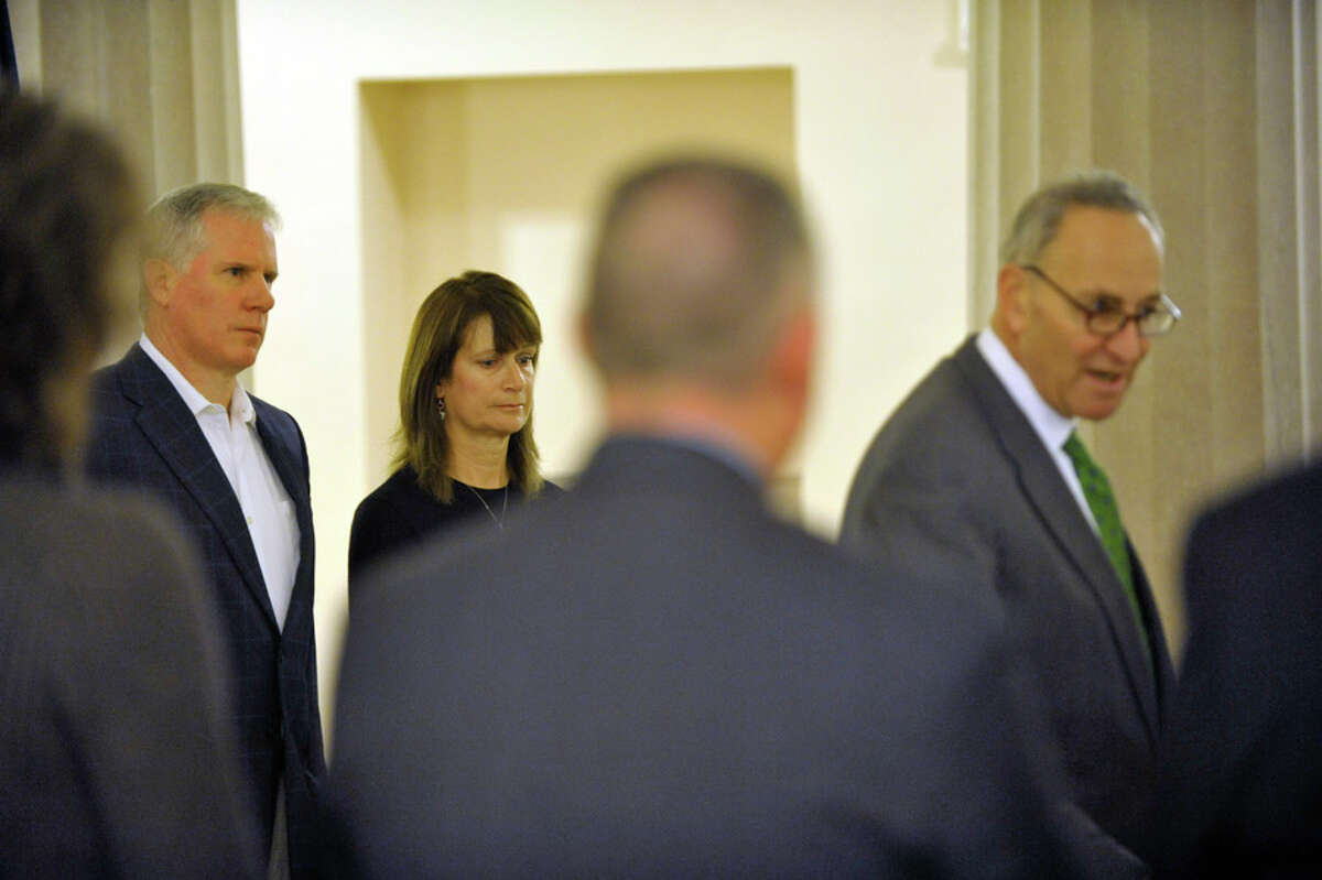 Kevin and Diane Flood with U.S. Sen.  Charles E. Schumer  at the Albany County Courthouse in 2014, advocating for a proposed $100 million surge in federal funding to combat heroin addiction. (Paul Buckowski / Times Union)