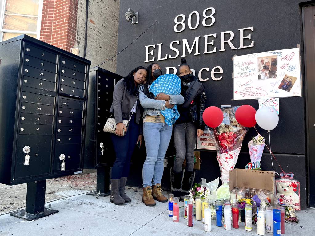 The family of Tyquen Pleasant by a memorial outside of his home. (L-R) Kawanna Pleasant, Latonda Pleasant, center, holding Tyquen's 5-week-old son and Jayvonna Rucker, 25, the victim's fiancée.