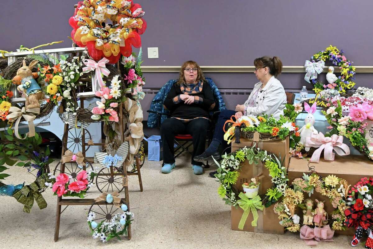 Carol Wold and Linda Carducci sell wreaths during a village-wide craft and vendor fair on Saturday, April 1, 2023, in Altamont, NY.