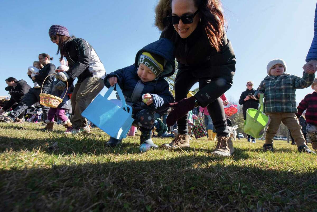 Kids scamper with their parents to find Easter eggs during annual Eggstravaganza at Elm Avenue Park on Sunday April 2, 2023 in Bethlehem, N.Y.