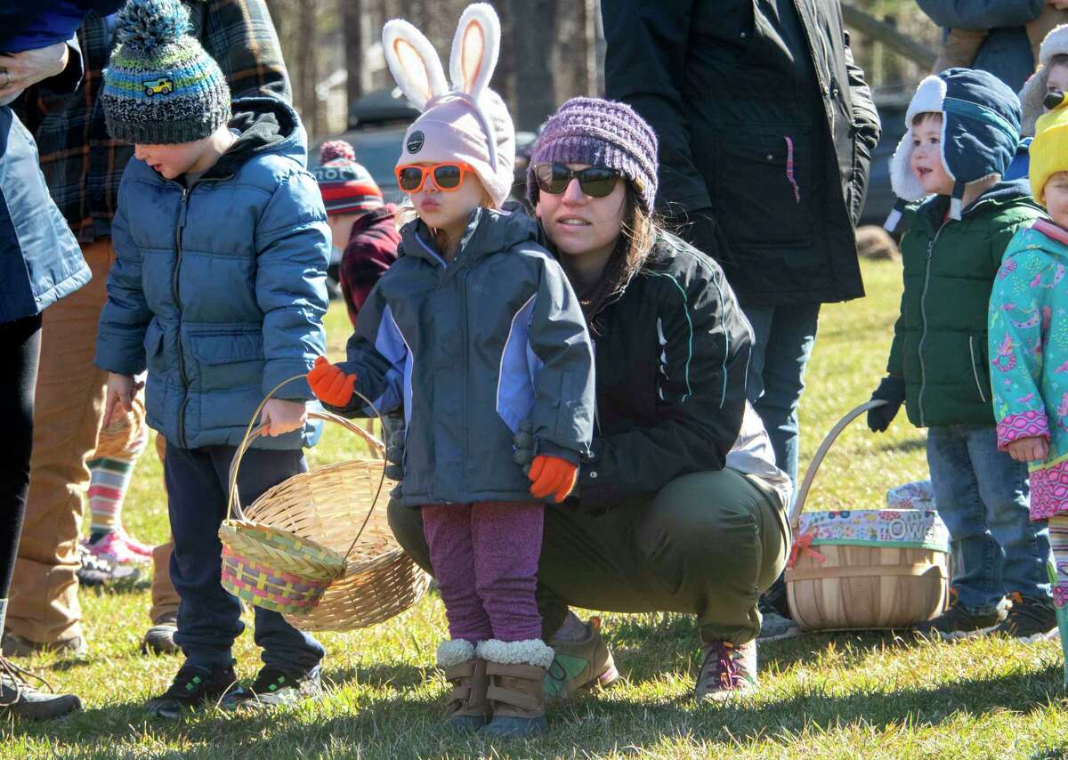 Maryann Yeager, 3, of Glenmont, accompanied by her mother Kallie, gets ready to find Easter eggs during annual Eggstravaganza at Elm Avenue Park on Sunday April 2, 2023 in Bethlehem, N.Y.