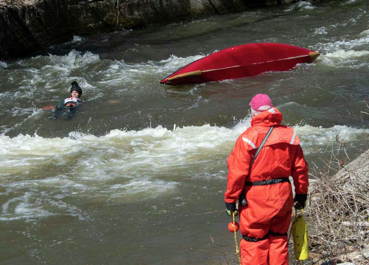 Participants fall out of their canoe as they compete in the 48th Annual Tenandeho White-Water Derby on the Anthony Kill on Sunday April 2, 2023 in Mechanicville, N.Y.