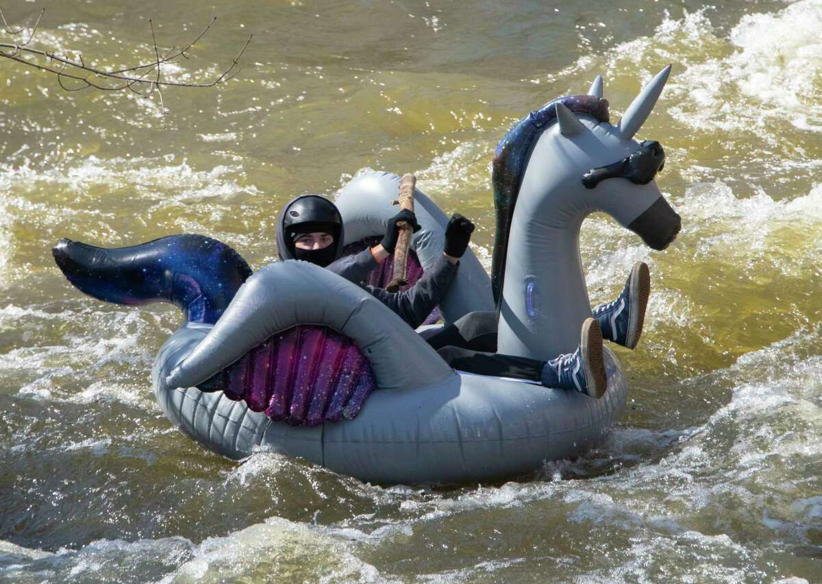 People are seen participating in the Anything That Floats Regatta in the 48th Annual Tenandeho White-Water Derby on the Anthony Kill on Sunday April 2, 2023 in Mechanicville, N.Y.