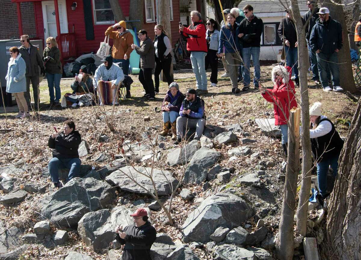 People take photos of a real duck who snuck in the Anything That Floats Regatta in the 48th Annual Tenandeho White-Water Derby on the Anthony Kill on Sunday April 2, 2023 in Mechanicville, N.Y.