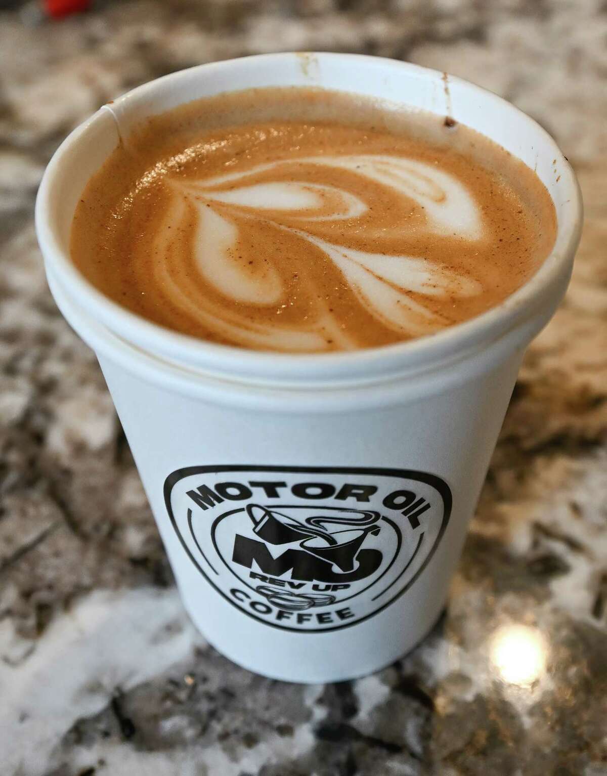 A cup of Motor Oil Coffee following a ribbon cutting on Wednesday, April 5, 2023, at a new shop on State Street in Albany, NY.