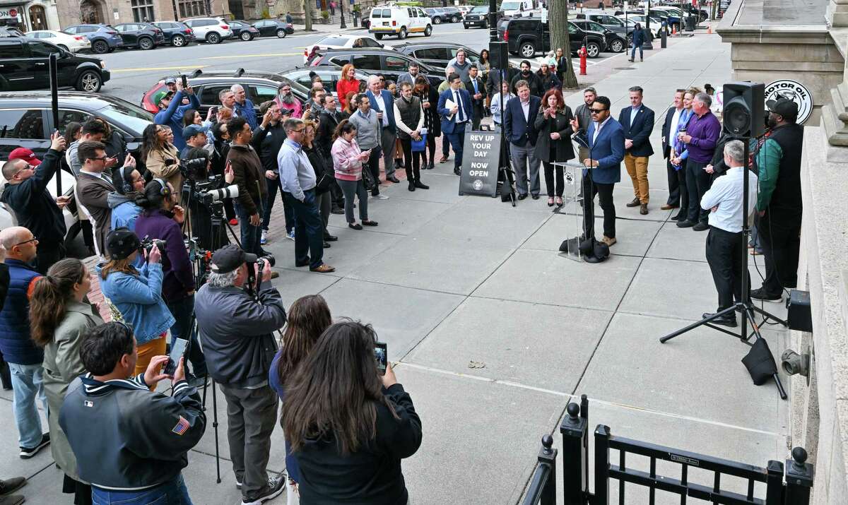 Joe Bonilla, co-founder of Motor Oil Coffee, speaks at a ribbon cutting on Wednesday, April 5, 2023, for a new shop on State Street in Albany, NY.