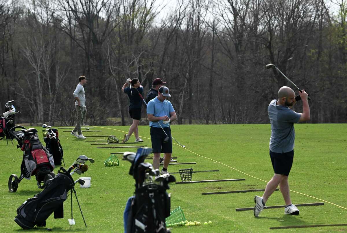 Golfers tune-up on the driving range at Capital Hills Golf Course during opening day for the city course on Friday, April 14, 2023, in Albany, N.Y.