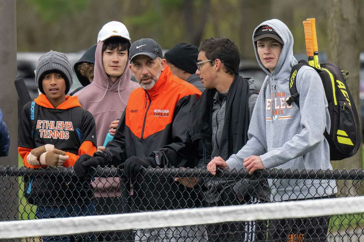 Bethlehem varsity boys tennis coach Steve Smith and some of his players watch a match against CBA on Wednesday, April 19, 2023, at UAlbany in Albany, NY. The win gives Smith his 300th victory.