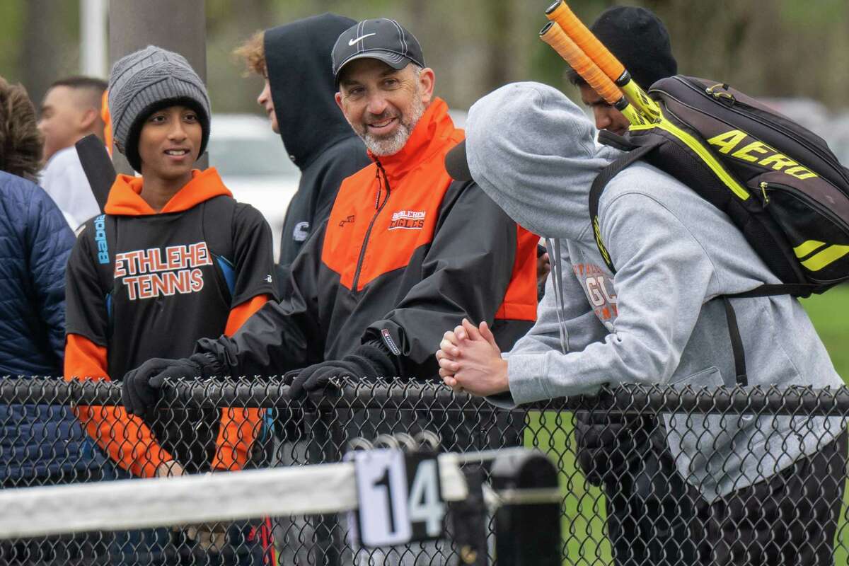 Bethlehem varsity boys tennis coach Steve Smith talks with his players during a match against CBA on Wednesday, April 19, 2023, at UAlbany in Albany, NY. The win gives Smith his 300th victory.