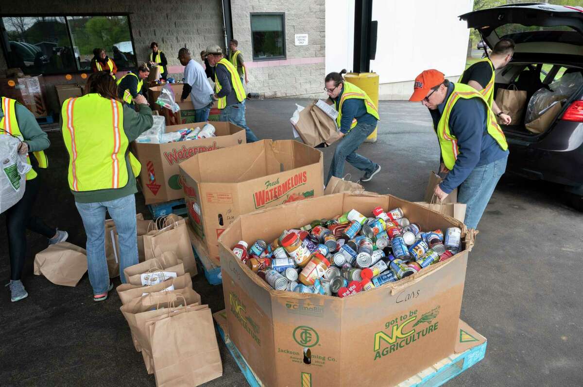 Volunteers at the Regional Food Bank unload donated food from cars and sort the food into cardboard bins during the 16th Annual Neighborhood Food Drive to benefit the Regional Food Bank of Northeastern New York on Sunday, April 30, 2023 in Colonie, N.Y.