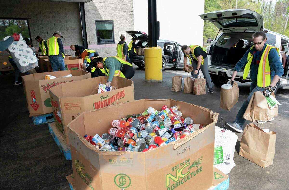 Volunteers at the Regional Food Bank unload donated food from cars and sort the food into cardboard bins during the 16th Annual Neighborhood Food Drive to benefit the Regional Food Bank of Northeastern New York on Sunday, April 30, 2023 in Colonie, N.Y.