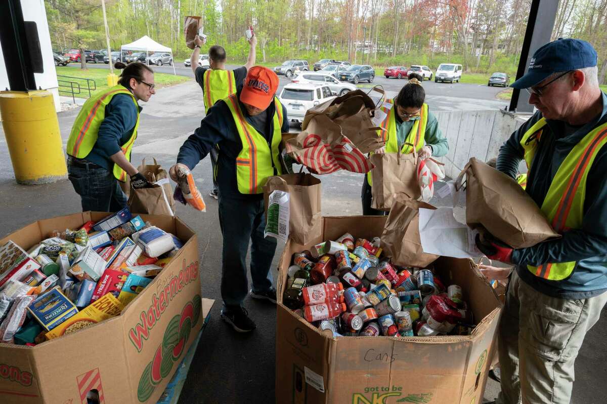 Volunteers sort donated food into cardboard bins during the 16th Annual Neighborhood Food Drive to benefit the Regional Food Bank of Northeastern New York on Sunday, April 30, 2023 at the Regional Food Bank in Colonie, N.Y.