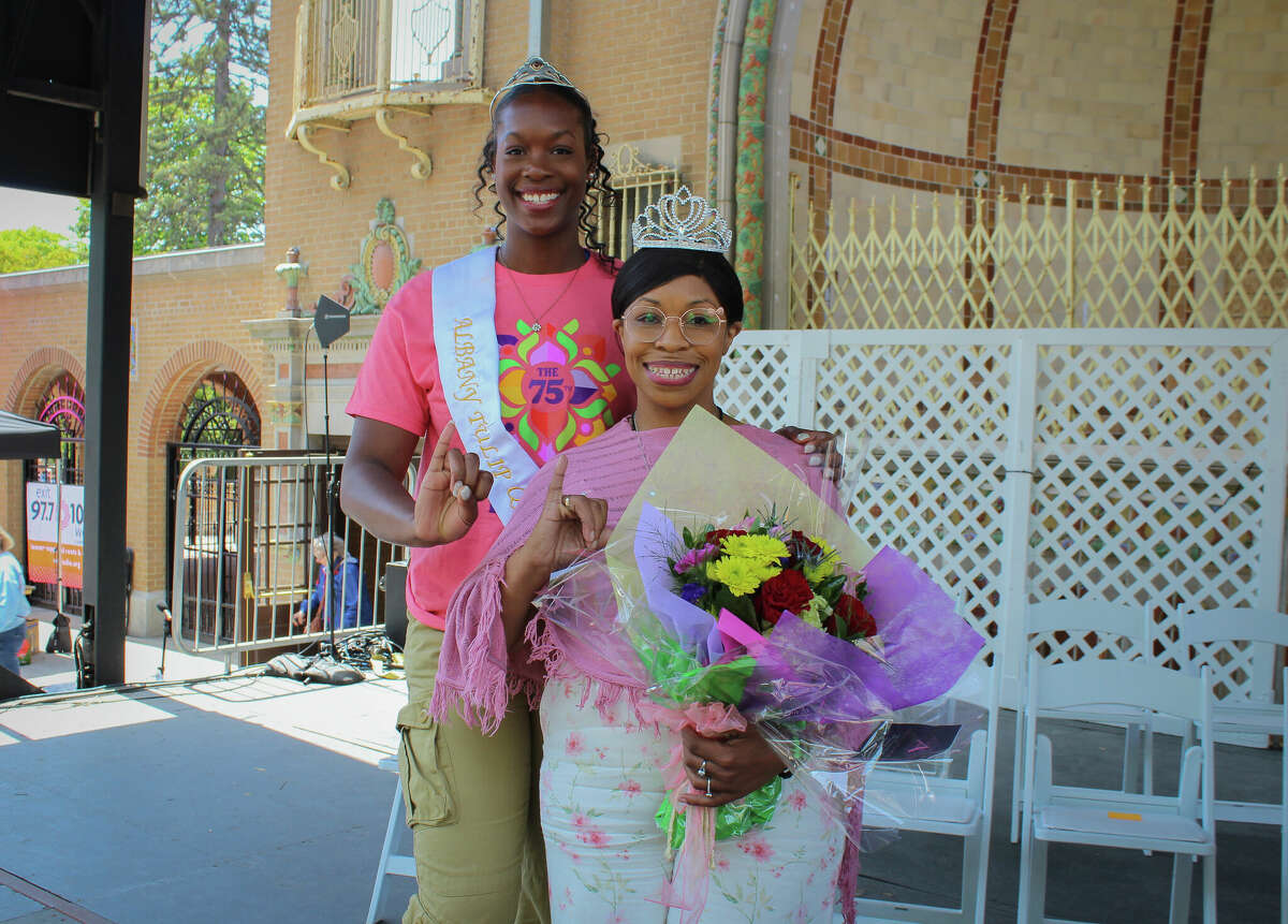 Tulip Queen Olivia Owens, left, and Captial Region Best Mom of the Year Leah Reed, right, pose for pictures on the final day of the Tulip Festival on Sunday, May 14, 2023, in Albany, N.Y.