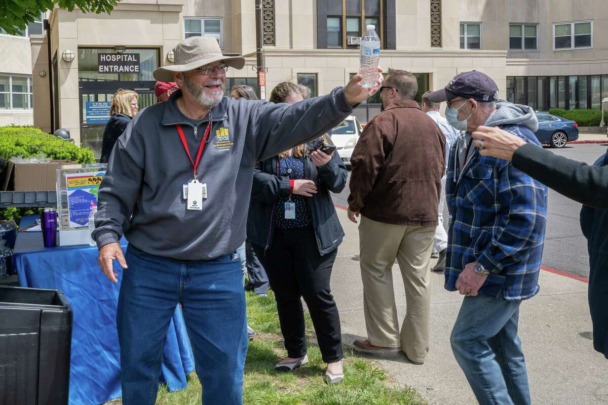 John Abrams hands out bottles of water during the 13th annual VA2K Walk and Roll fundraiser held to support the Homeless Veterans Program at the Samuel S. Stratton Department of Veterans Affairs Medical Center on Wednesday, May 17, 2023, in Albany, NY.