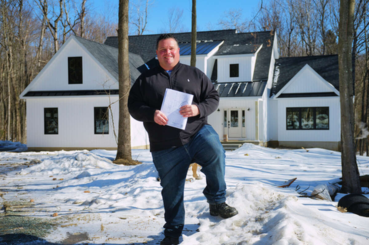 Jeff McDonald, owner of McDonald Custom Homes, stands outside one of homes he designed and built in the Tabor Woods subdivision on Tuesday, March 2, 2021, in the Town of Halfmoon.