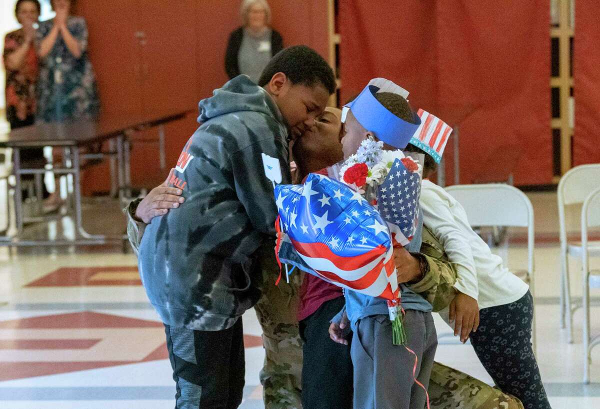 Sgt. 1st Class William C. Rhodes of the Army National Guard reunites with his children, from left, third grader Jaymon, and kindergarten triplets Carson, Langston and Jordyn with his return at Bradt Elementary School on Monday, May 22, 2023 in Rotterdam, N.Y.