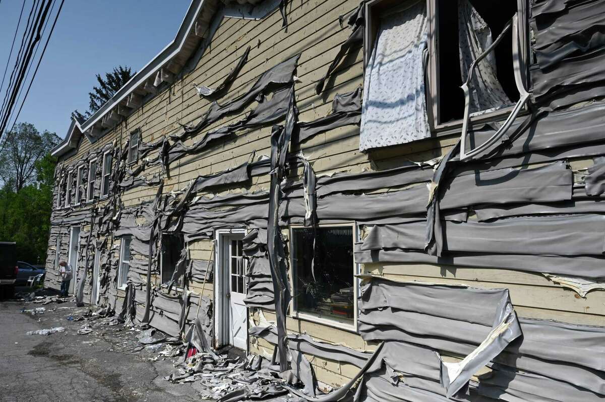 Siding is melted on a building across the street from 546 River Rd. following a fatal fire that destroyed the neighboring property on Friday, May 19, 2023, in Schodack Landing, N.Y.