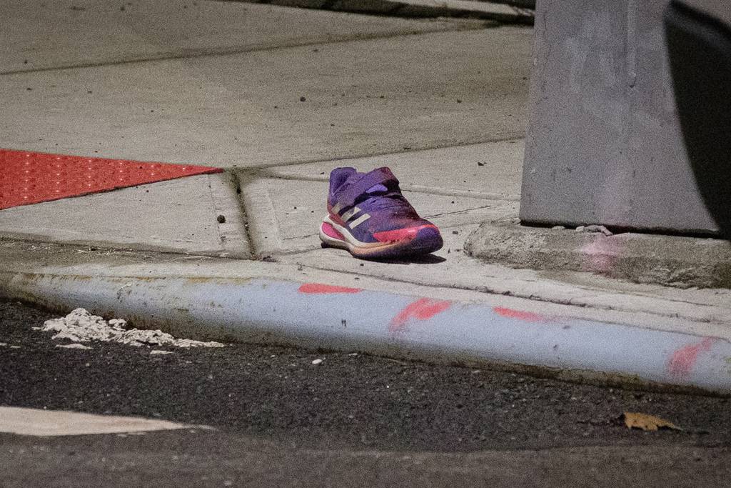 A child's shoe is seen in the street after a girl was fatally struck by a driver on Newtown Road and 46th Street in Queens on Feb. 17.