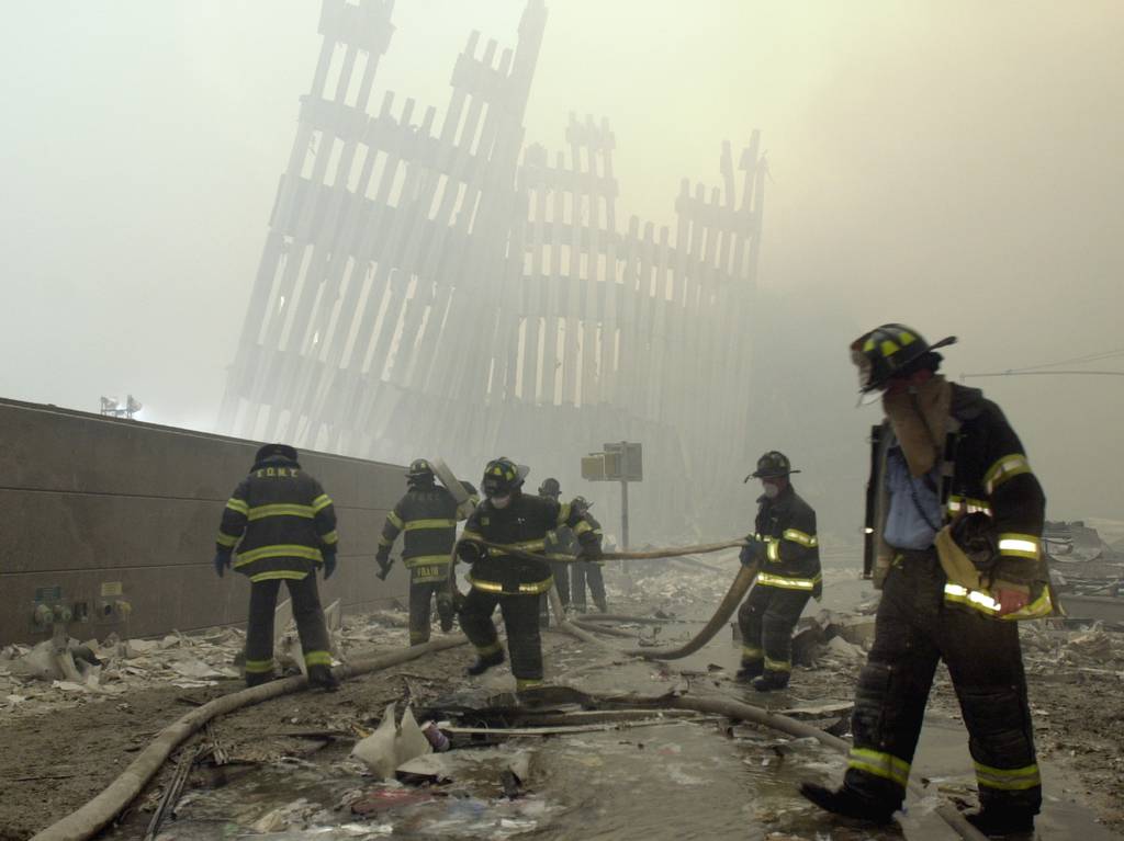 In this Sept. 11, 2001 file photo, firefighters work beneath the destroyed mullions.