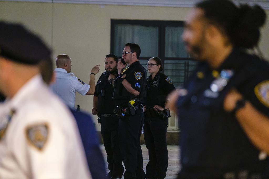 NYPD cops investigate the double shooting on Drew St. in East New York, Brooklyn, Saturday.