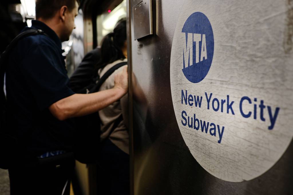 Passengers crowd into a subway train.