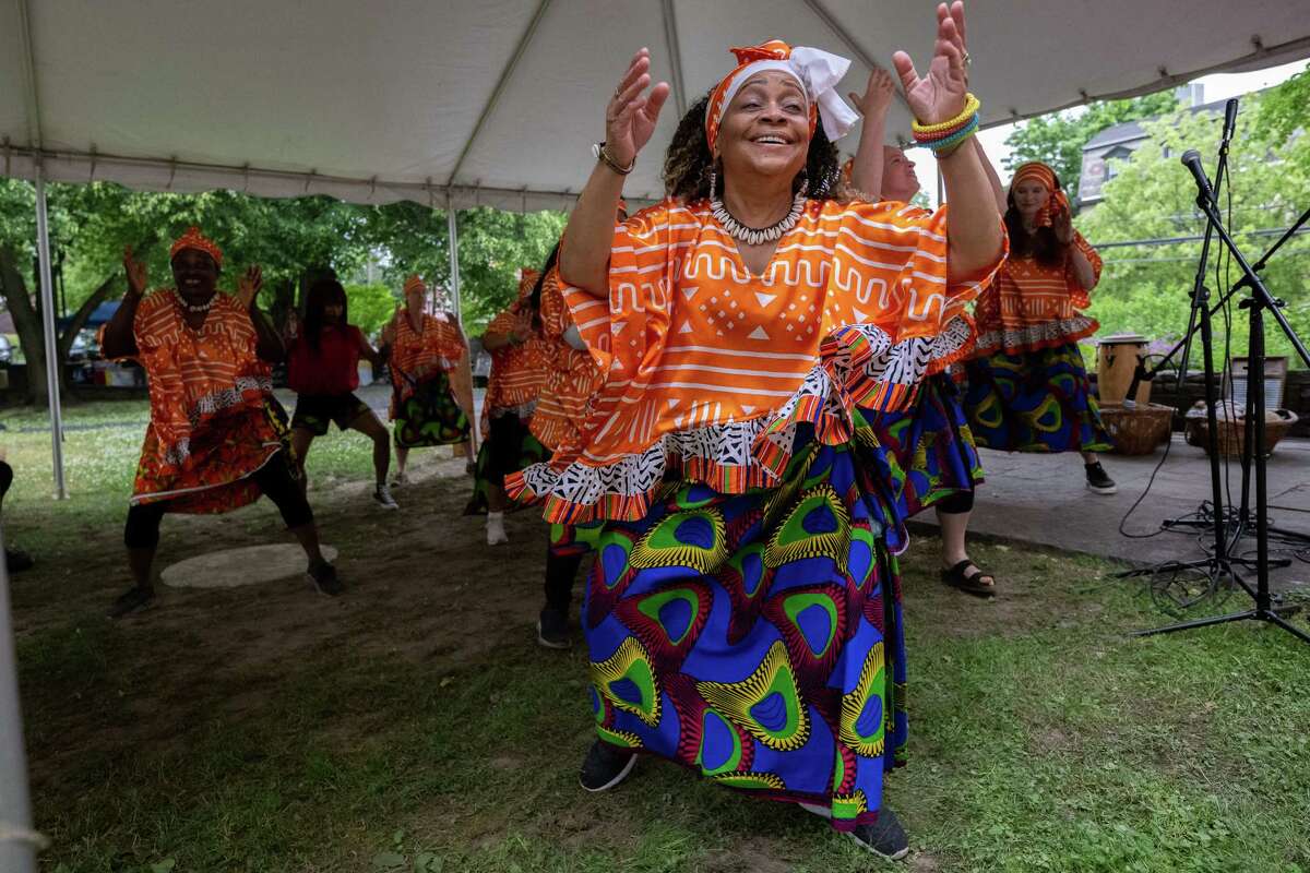 Elena Mosley and members of Operation Unite NY dance to music by Zorkie Nelson during Pinkster — which began as a Dutch holiday but became an African celebration of family, hope and cultural identity — on Saturday, June 3, 2023, at Schuyler Mansion in Albany, NY.