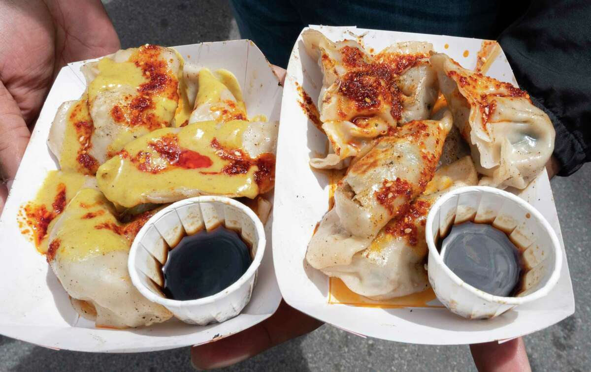 Heimdall Imbert of Latham holds a couple orders of dumplings from the Baba Duck booth as the Capital Region Vegan Network holds their annual Veg Out event featuring vegan food from area restaurants on Sunday, June 4, 2023 in Troy, N.Y. Heimdall has been vegan for 87 years.