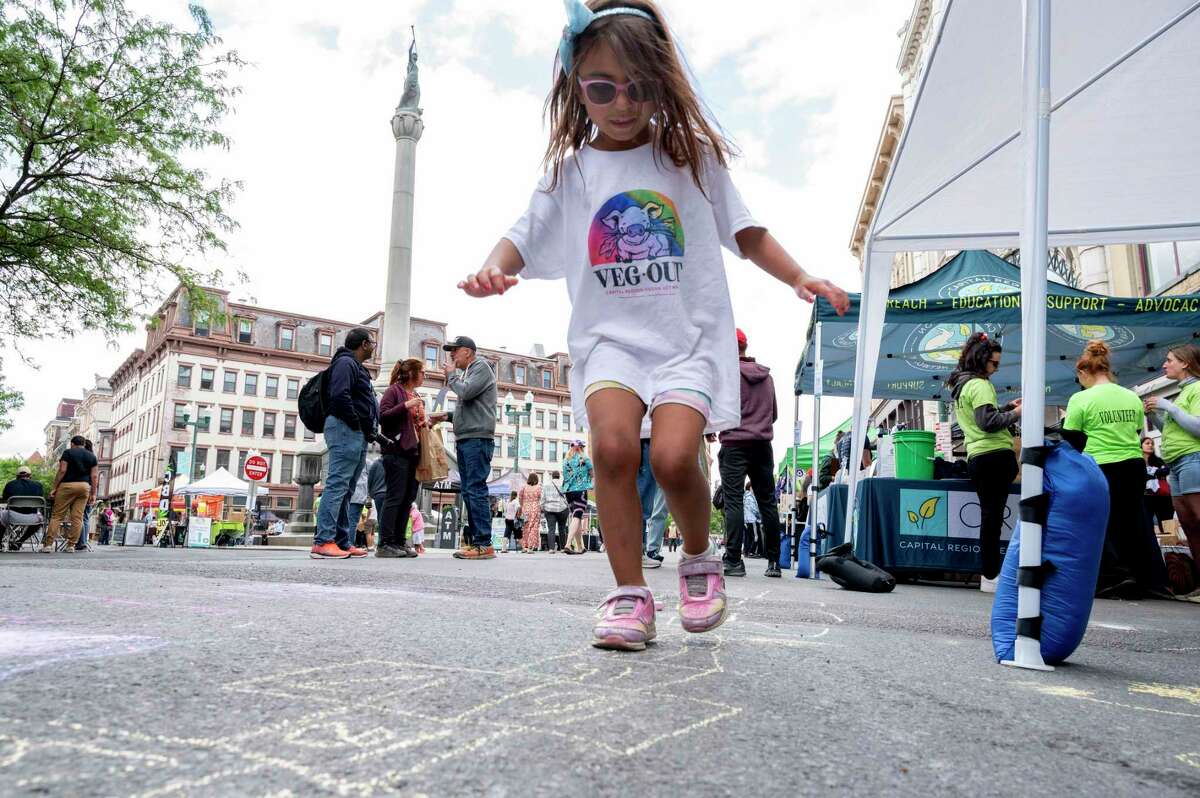 Anika Jain, 4, of Malta, enjoys playing hopscotch as the Capital Region Vegan Network holds its annual Veg Out event featuring vegan food from area restaurants on Sunday in downtown Troy. Anika’s family of four and extended family are all vegan. 