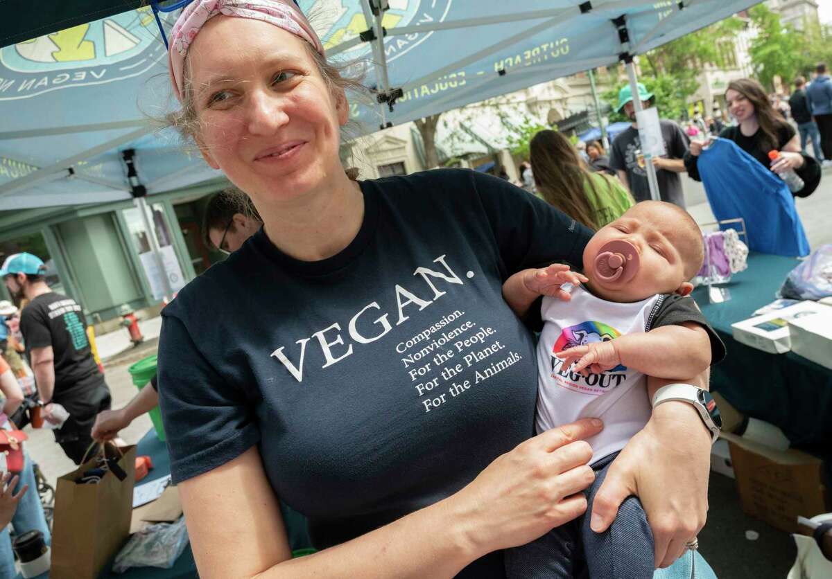 Claire Henderson Jain of Malta holds her 2 mos. old niece Juniper of Niskayuna as the Capital Region Vegan Network holds their annual Veg Out event featuring vegan food from area restaurants on Sunday, June 4, 2023 in Troy, N.Y. Claire, her family and her sister’s family are all vegan.