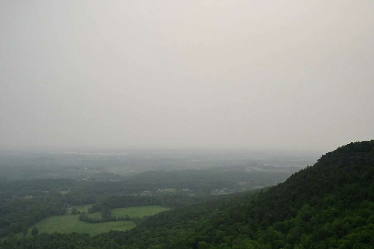 Thick smoke from Canadian wildfires clouds the view from John Boyd Thacher State Park on Tuesday, June 6, 2023, in New Scotland, N.Y. The region is under an air quality advisory as smoke moves down from the more than 100 active wildfires in burning Quebec.