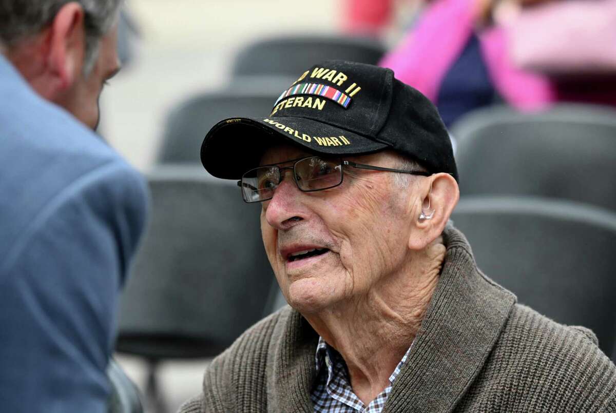 Guilderland WWII veteran Austin Hutton, 104, is congratulated by Albany County Deputy Executive Daniel Lynch, left, during a ceremony to recognize the addition of Hutton, and eight fellow Guilderland vets, to this year’s Guilderland hometown heroes banners on Friday at Tawasentha Park in Guilderland. The program honors local heroes who have served and continue to serve in the Armed Forces. Eight new banners were sponsored by the American Legion, Fort Hunter Fire Department and several Guilderland families.