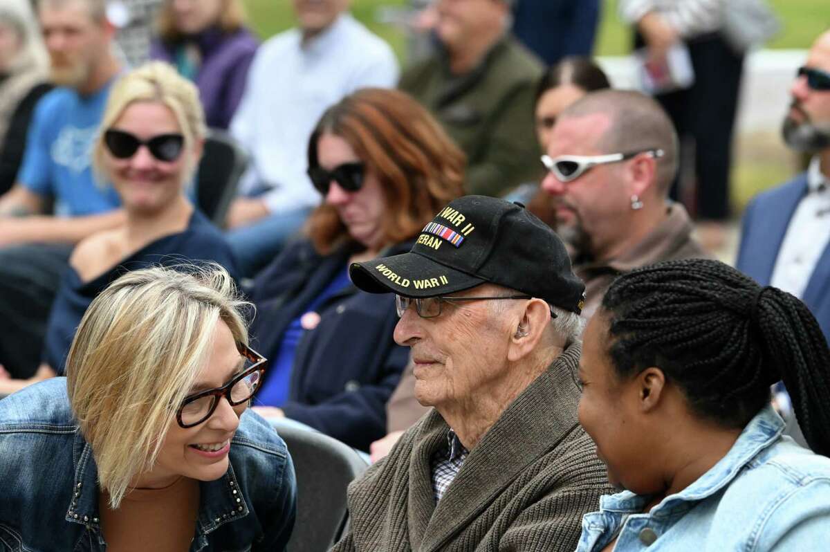 Guilderland WWII veteran Austin Hutton, 104, center, was honored by daughter, Mary, left, during a ceremony to recognize the addition of Hutton, and eight fellow Guilderland vets, to this year’s Guilderland hometown heroes banners on Friday  at Tawasentha Park in Guilderland. The program honors local heroes who have served and continue to serve in the Armed Forces. Eight new banners were sponsored by the American Legion, Fort Hunter Fire Department and several Guilderland families.