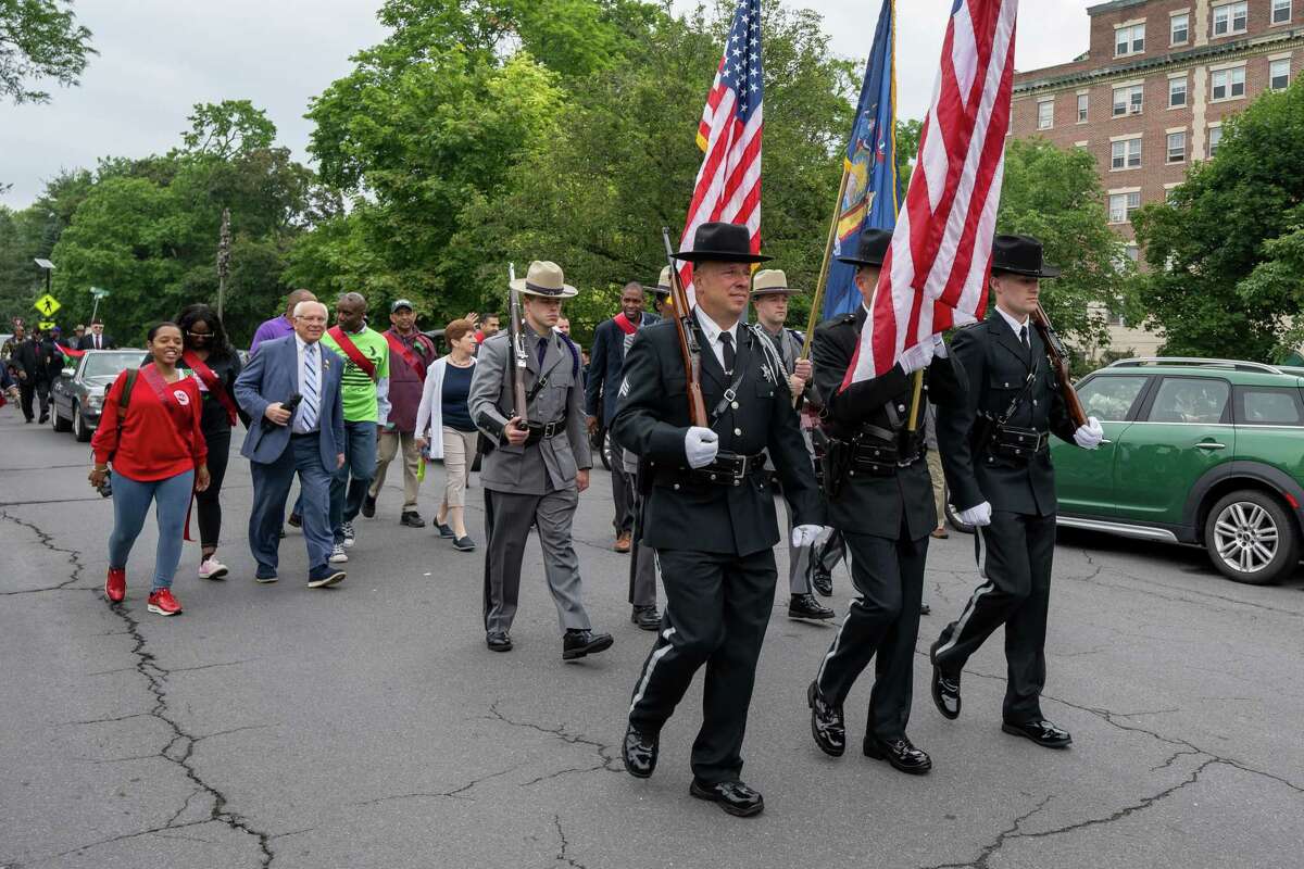 Albany County deputies and State Police troopers march during the Juneteenth Parade from Washington Park to the South End Grocery Store on Pearl Street on Saturday, June 17, 2023, in Albany, NY.