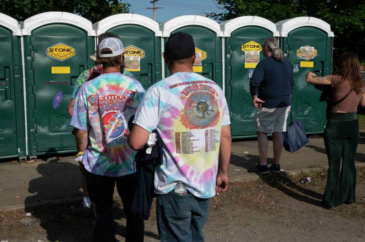 Fans wait in line for the portable toilets in the Shakedown Street parking lot before the last Dead and Company show at Saratoga Performing Arts Center on Sunday, June 18, 2023, in Saratoga Springs, N.Y. (Lori Van Buren/Times Union)