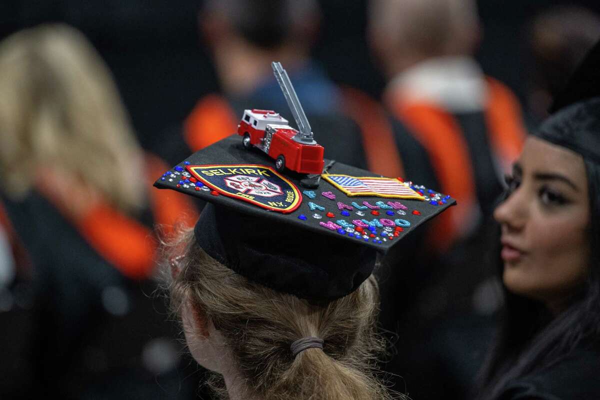 A Bethlehem High School graduate wears a cap decorated with a Selkirk Fire Department badge and a fire truck during her graduation ceremony on Friday, June 23, 2023, at the MVP Arena in Albany, NY.