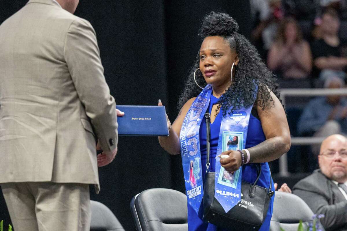 Tareen Lynch-Greene accepts an honorary diploma for her daughter, Destiny Greene, who was murdered in 2021, during the Shaker High School Class of 2023 commencement ceremony on Saturday, June 24, 2023, at the MVP Arena in Albany, NY.