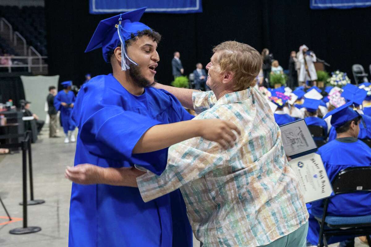 Marykay Smollin, a hall monitor at Shaker High School, gives graduate Mohamed Hussain a hug during the Shaker High School Class of 2023 commencement ceremony on Saturday, June 24, 2023, at the MVP Arena in Albany, NY.