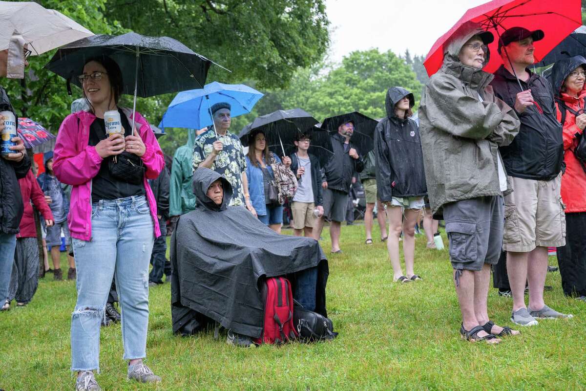 Luis Camacho, seated, is keeping dry during a rainy Freihofer’s Jazz Fest on Saturday, June 24, 2023, at the Saratoga Performing Arts Center in Saratoga, NY.